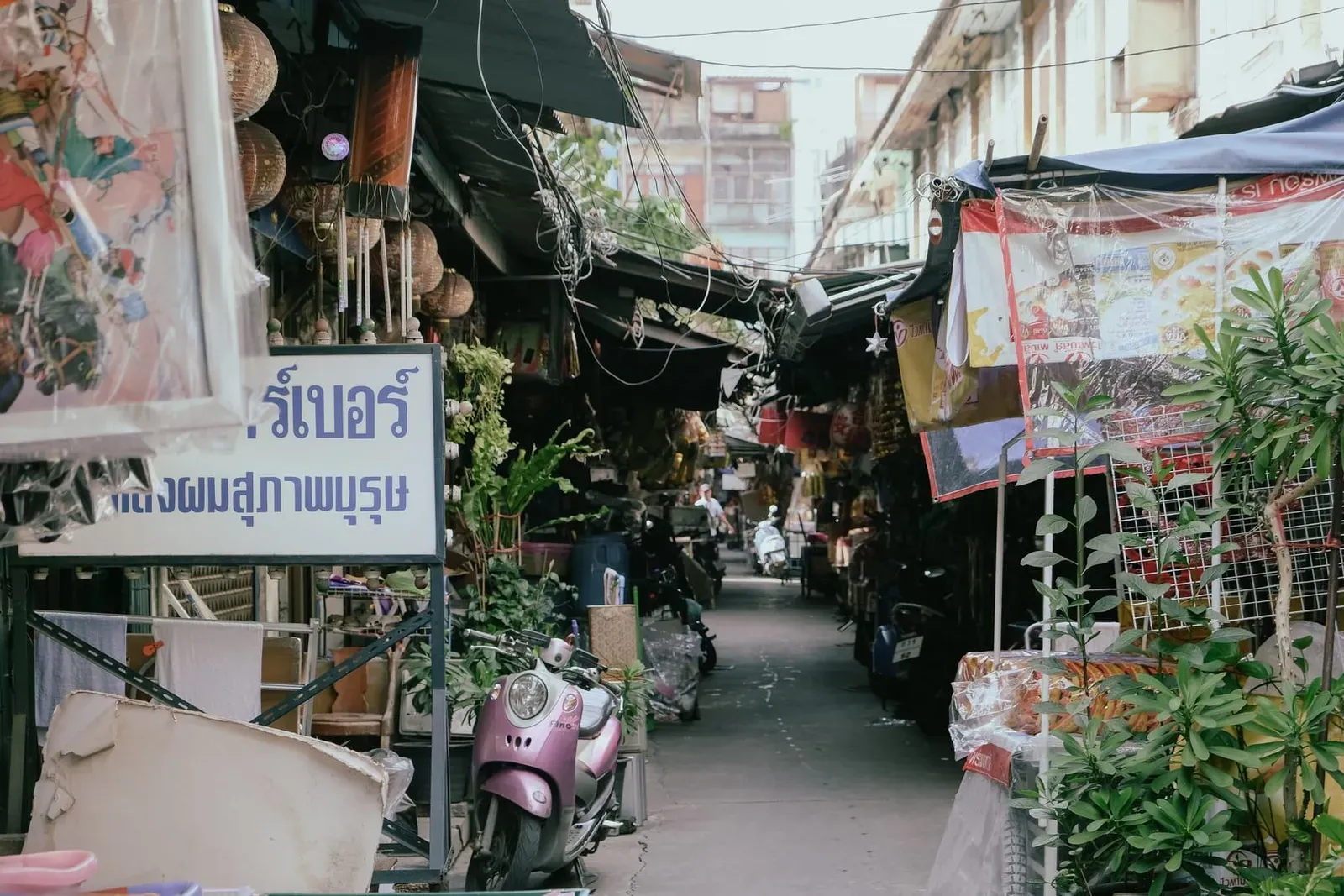 Scooter parked near a street market stall in a typical Koh Samui town scene