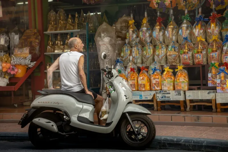 Scooter parked outside a Thai storefront, a budget transport option for exploring Koh Samui