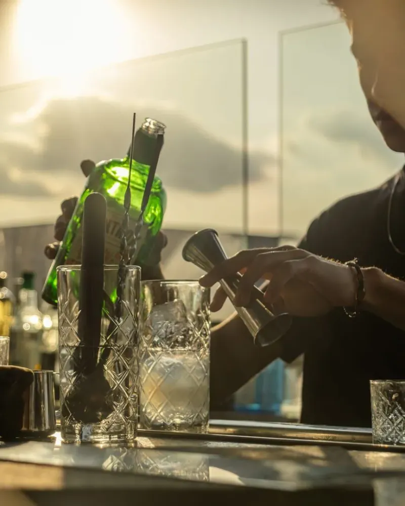 Bartender preparing a cocktail at a Koh Samui sunset bar