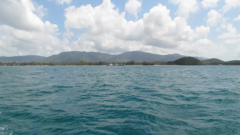 View of Koh Samui's west coast hills and shoreline from the water near Nathon
