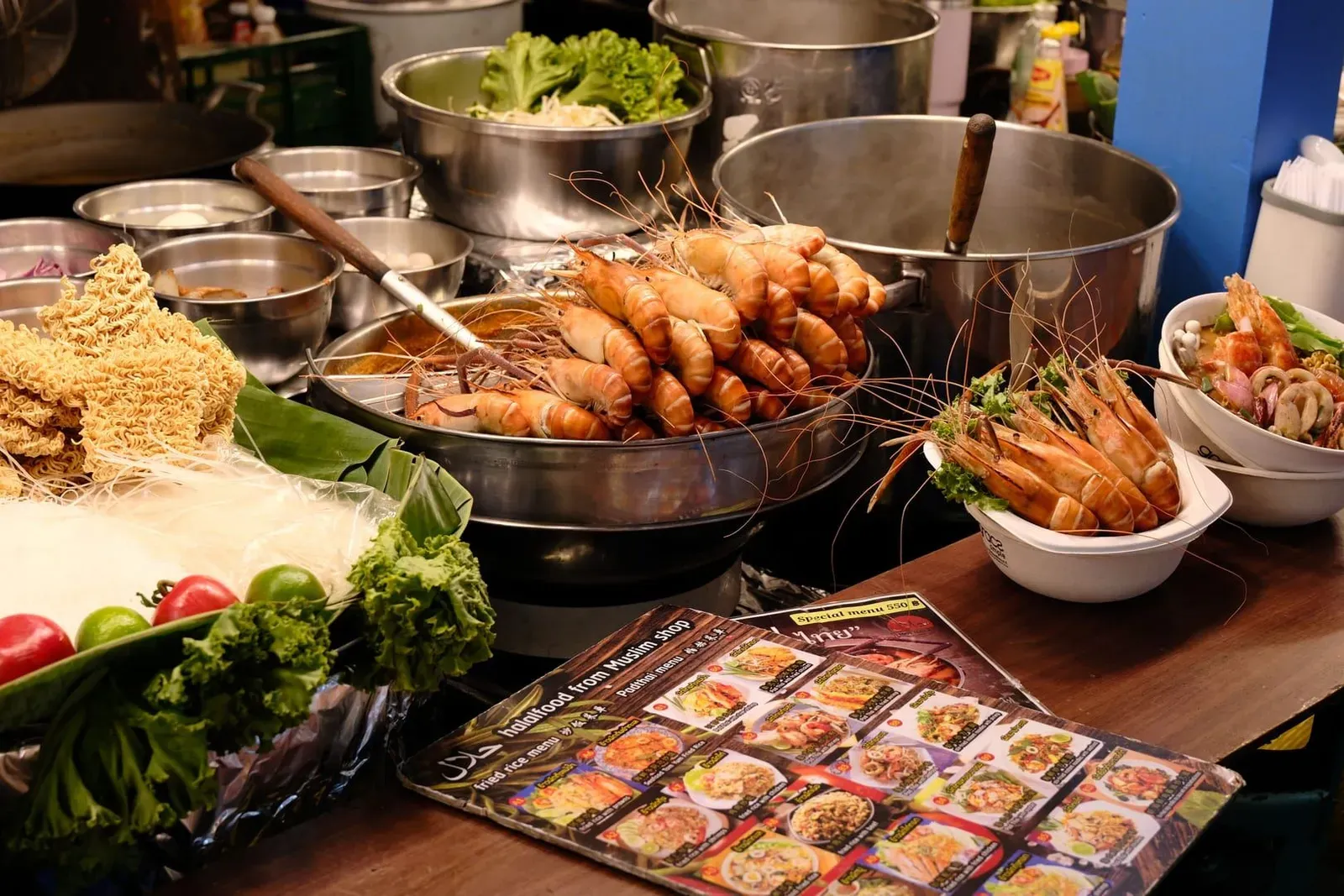 Thai seafood meal served under cover at a beachfront restaurant during rainy weather on Koh Samui