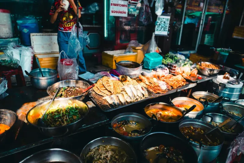 Vibrant Thai food market stall with fresh produce for a Koh Samui cooking school