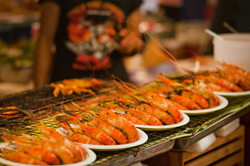 Plates of grilled shrimp ready to serve at a Koh Samui street food stall