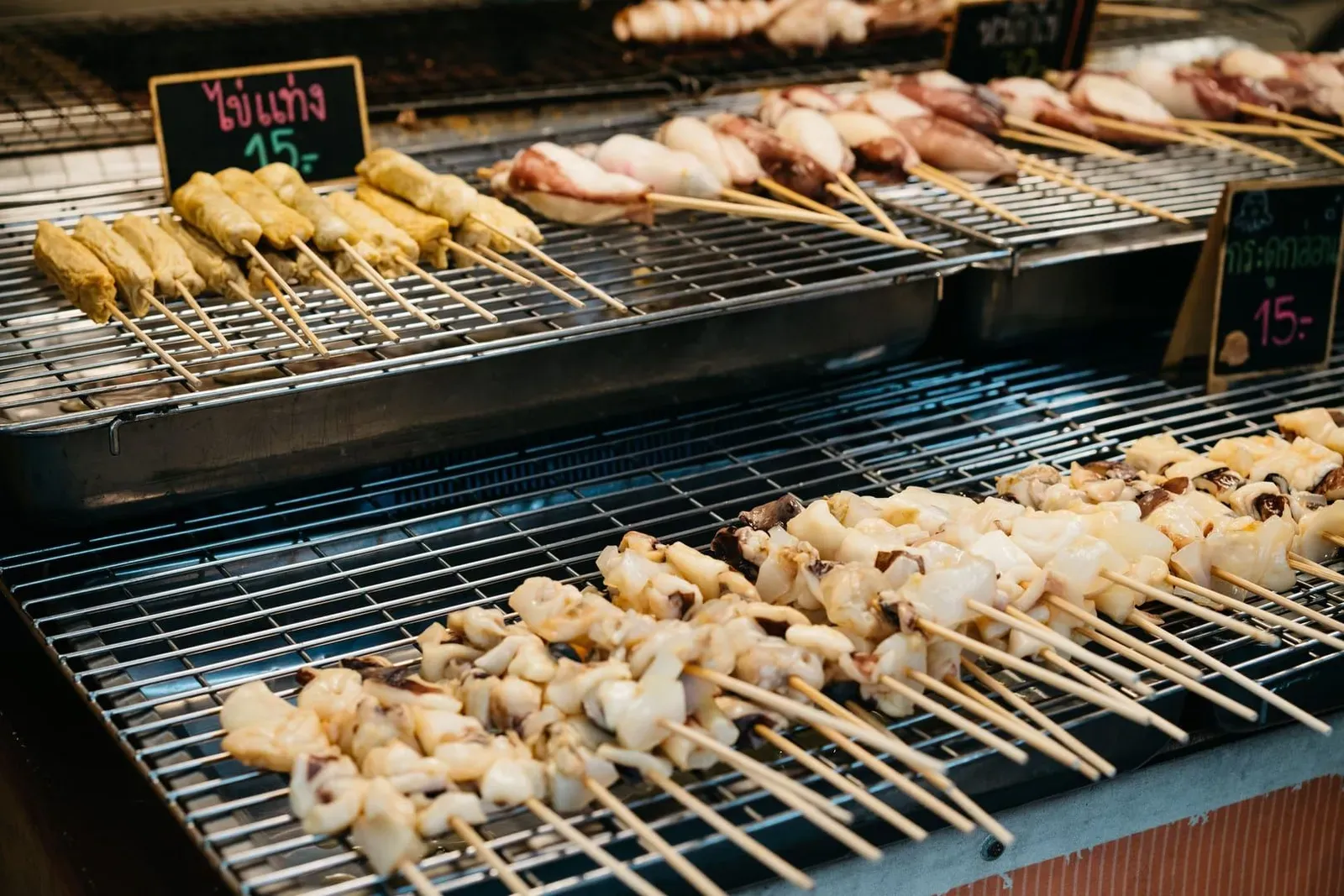 Raw meat and seafood skewers ready to grill at a Thai market stall on Koh Samui