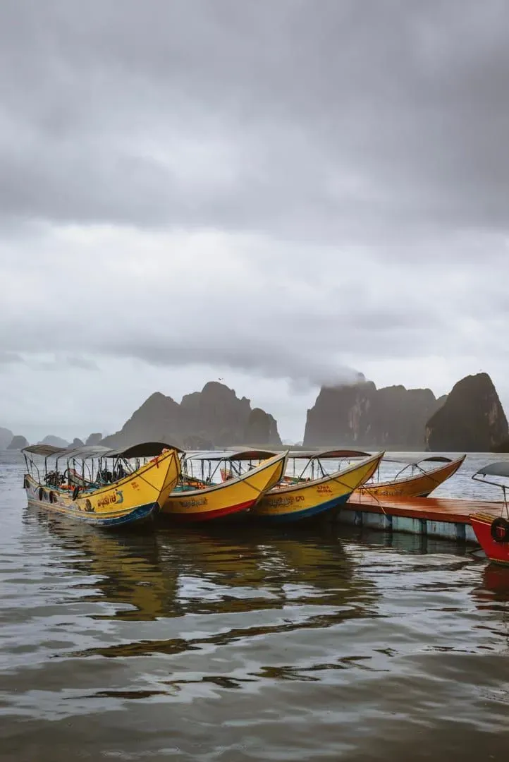 Traditional longtail boats anchored near a Koh Samui pier used for island transfers