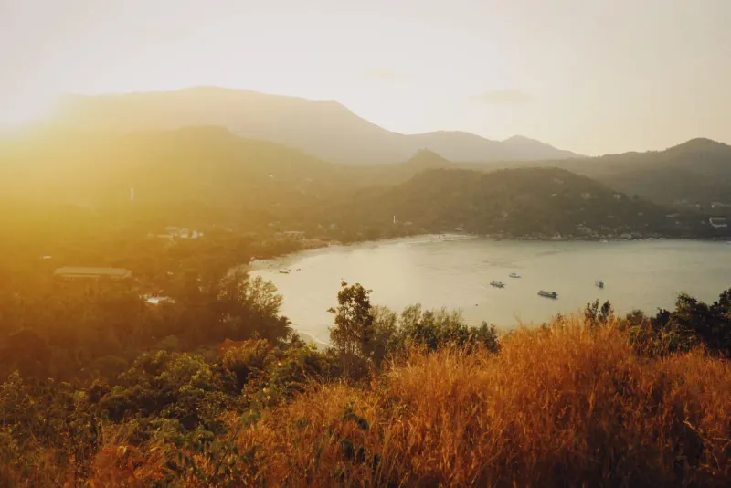 View from a hillside overlooking a bay at sunset similar to Samui 360 Viewpoint