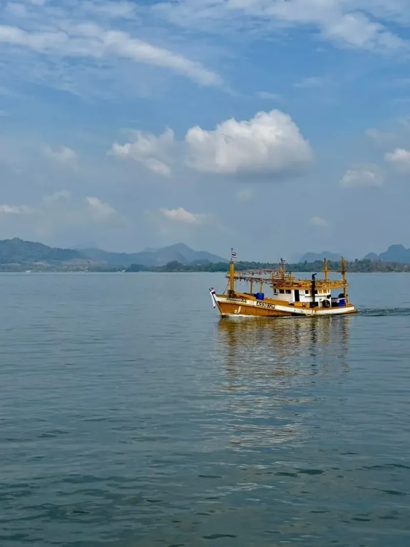 Traditional Thai fishing boat on calm water off the Krabi coast