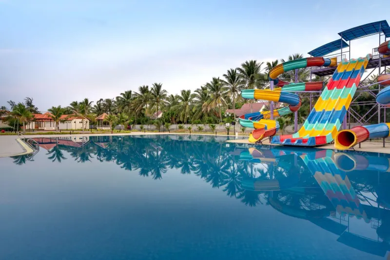 Water slides beside a calm pool at a Koh Samui-style family water park