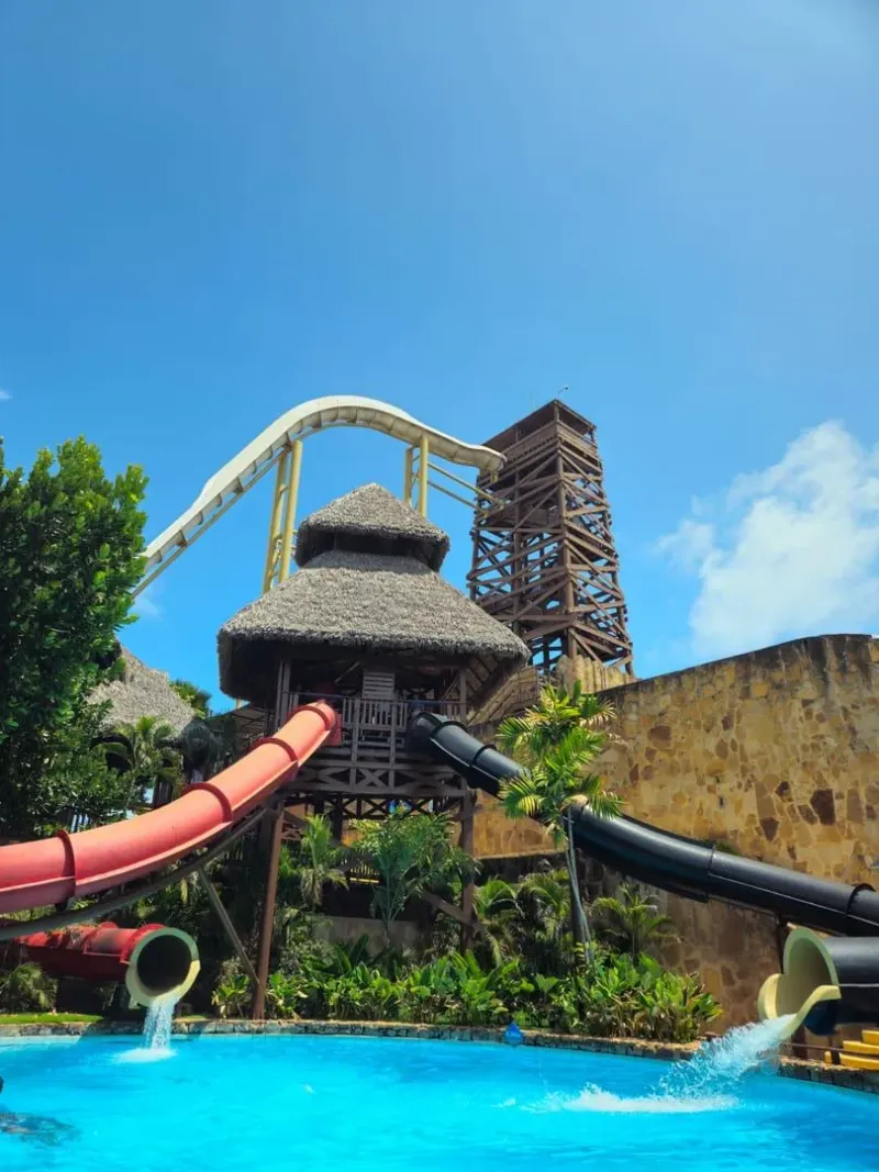 Tall water slides at a tropical adventure park similar to Samui Water Park Maenam
