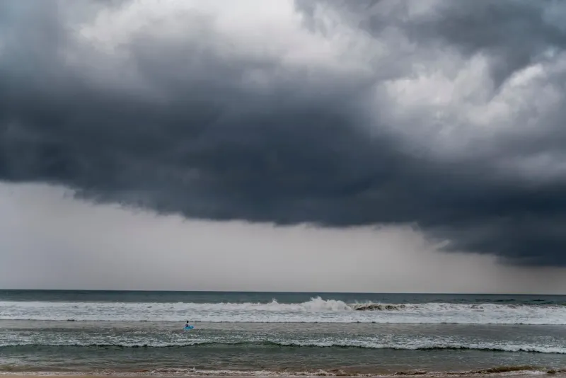 Dark storm clouds building over rough sea waves during Koh Samui's northeast monsoon