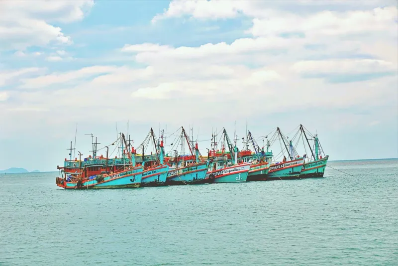 Colorful fishing boats floating in the Gulf of Thailand near a Koh Samui pier