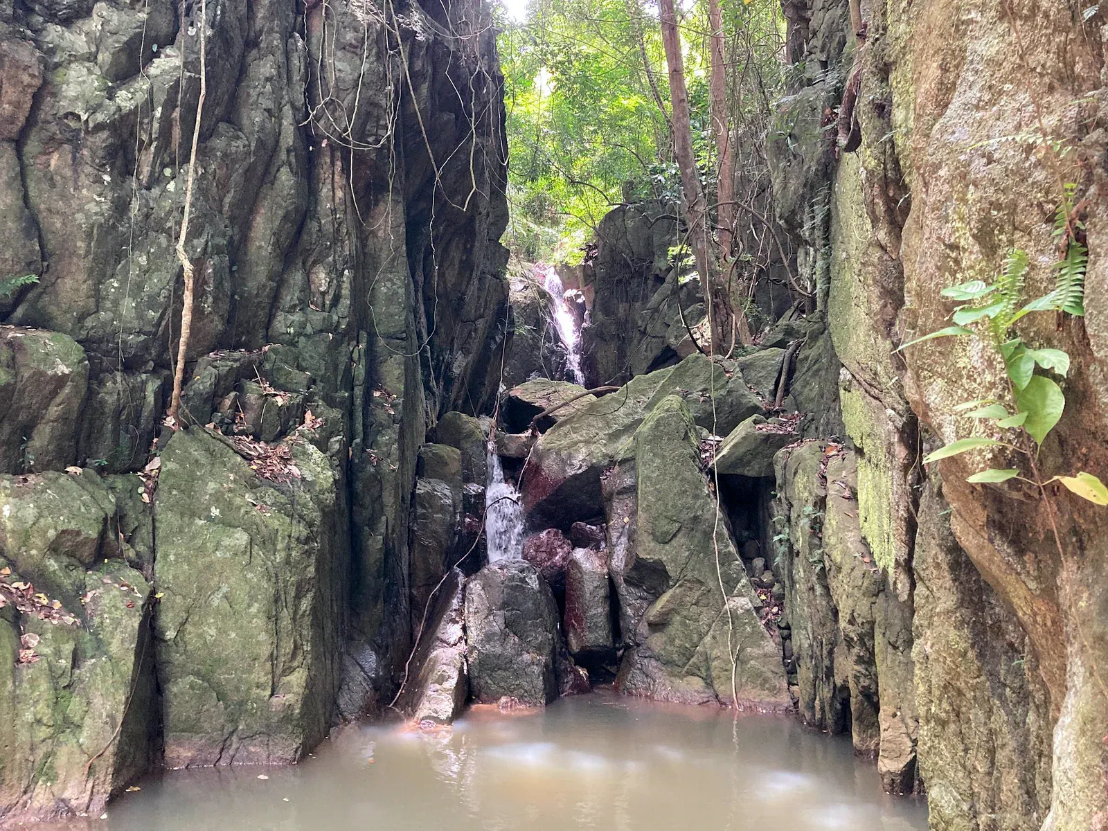 Agua descendiendo por formaciones rocosas escalonadas en la Cascada Lat Wanon