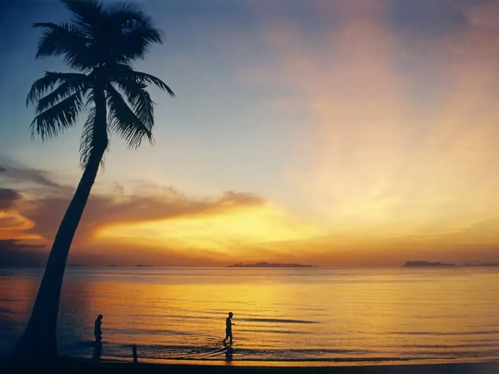 Golden sunset over Lipa Noi Beach on Koh Samui's west coast with the Ang Thong islands on the horizon