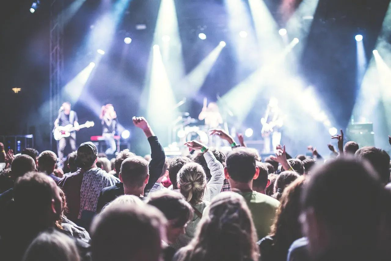 Crowd watching a band on a festival stage