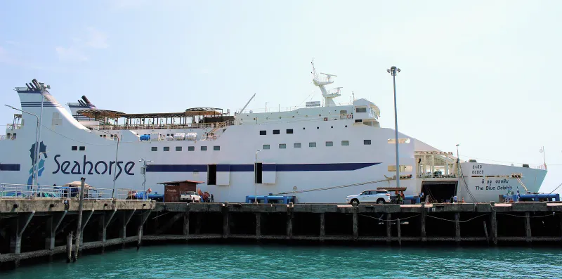 Grand ferry de croisière blanc Seahorse accosté à un quai en béton sous un ciel pâle