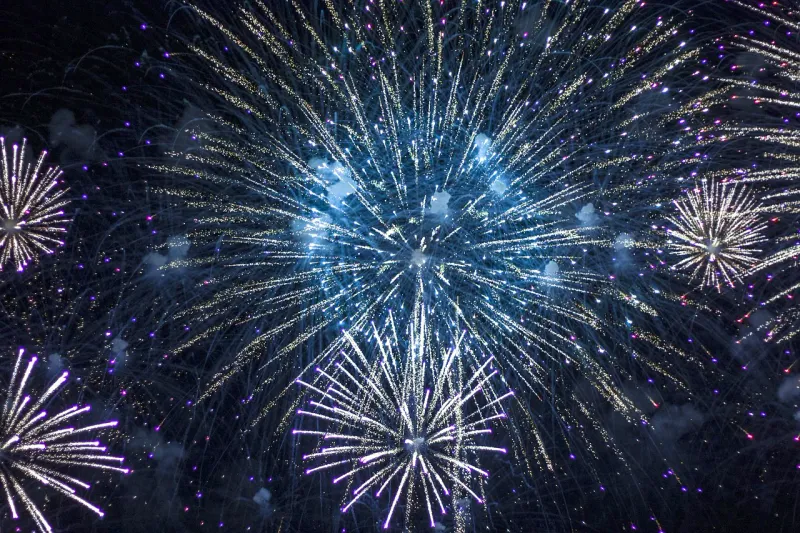 Blue fireworks bursting in the night sky