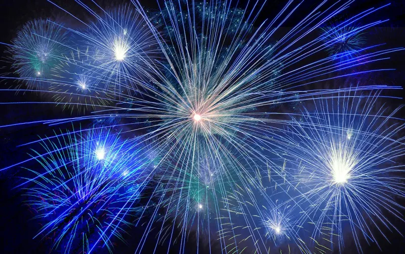 Blue fireworks bursting in the night sky