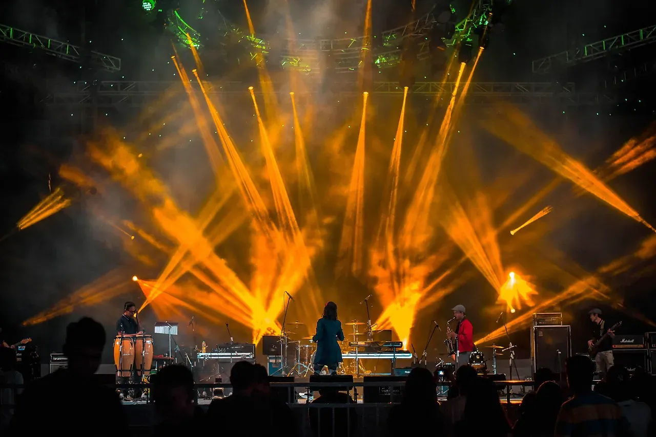 Orange stage lights over a crowd at a club night
