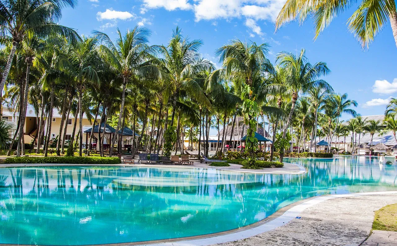 Resort pool lined with palm trees