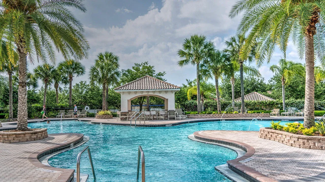 Resort pool with a gazebo and palm trees