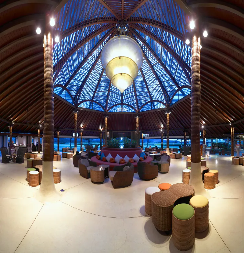 Sala del terminal a cielo aperto con tetto in legno all'aeroporto di Koh Samui, con arredi tropicali