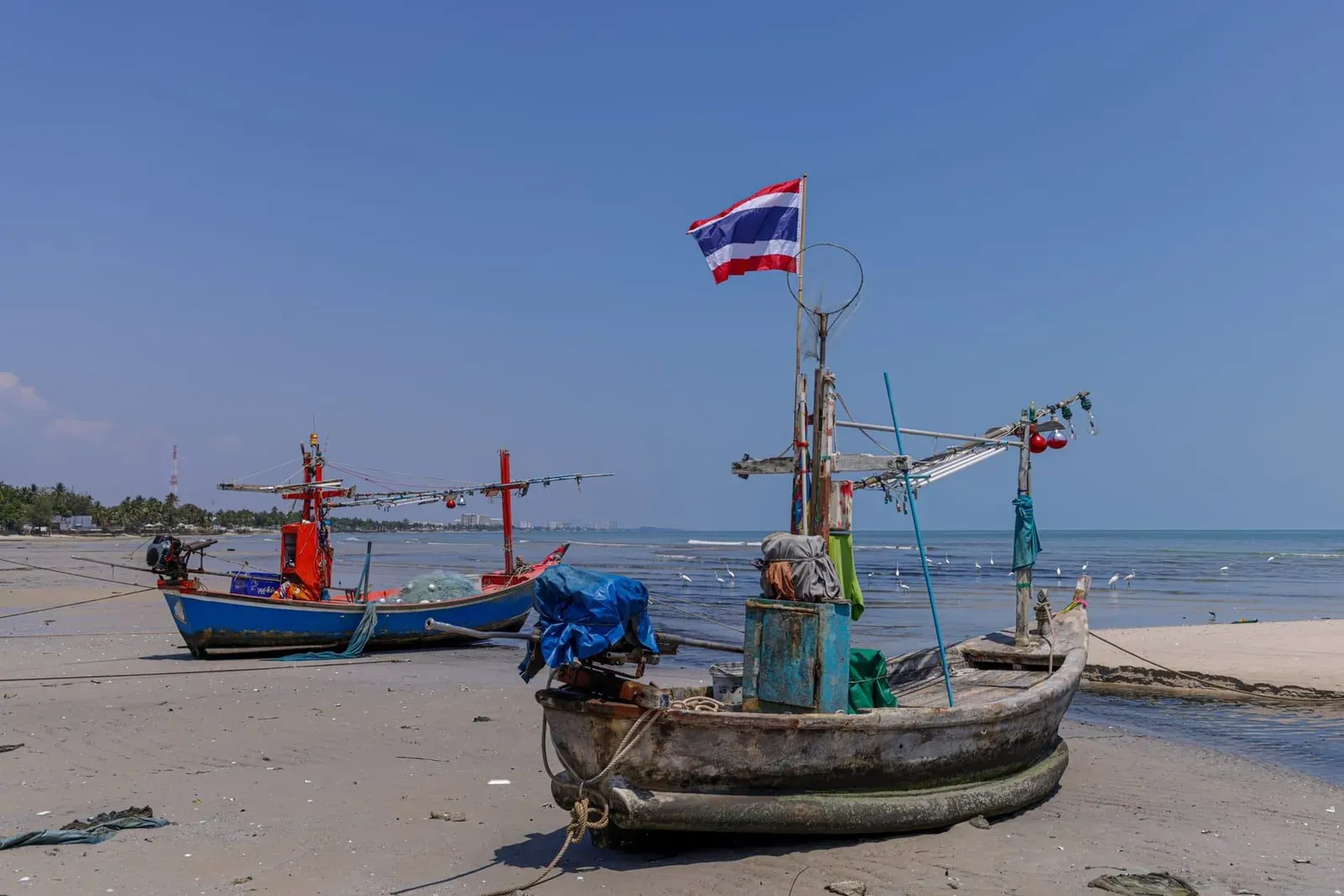 Fishing boats anchored off a quiet stretch of Bang Makham beach on Koh Samui's west coast