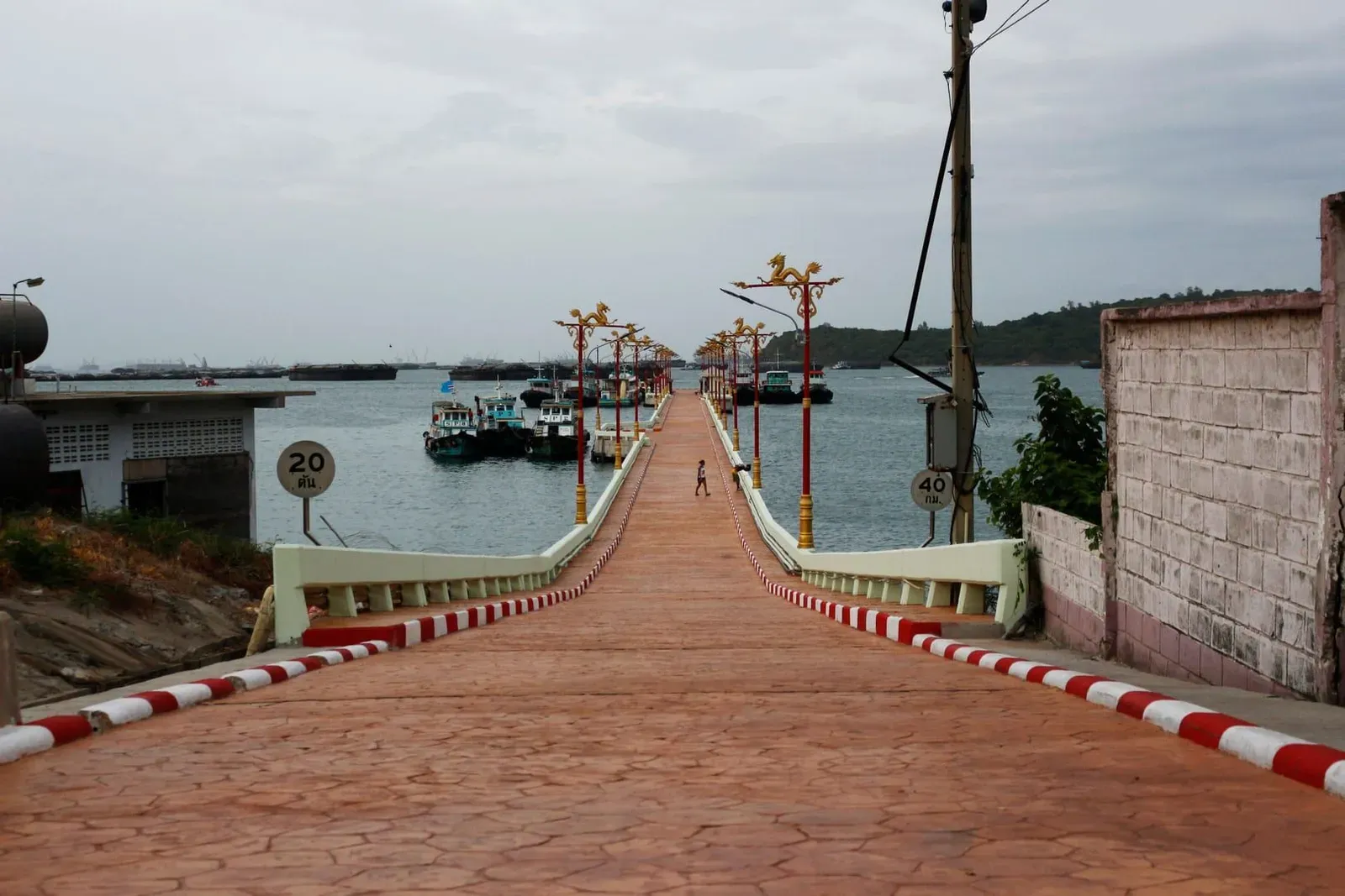 Quiet pier with fishing boats on calm water similar to Koh Samui's smaller ferry piers