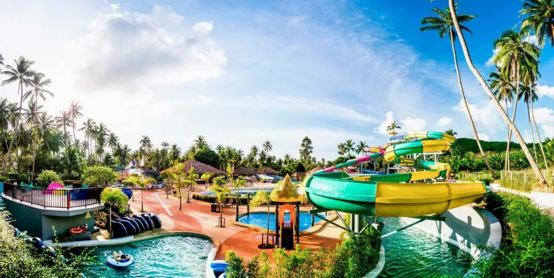 Samui Water Park's palm-shaded slide tower, listed on a Koh Samui water parks comparison site