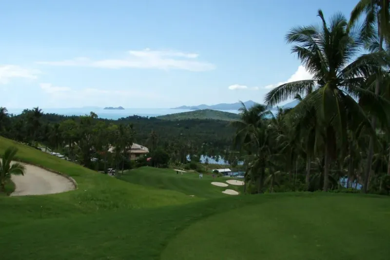 A fairway and green at Santiburi Samui Country Club, photographed from the hillside course