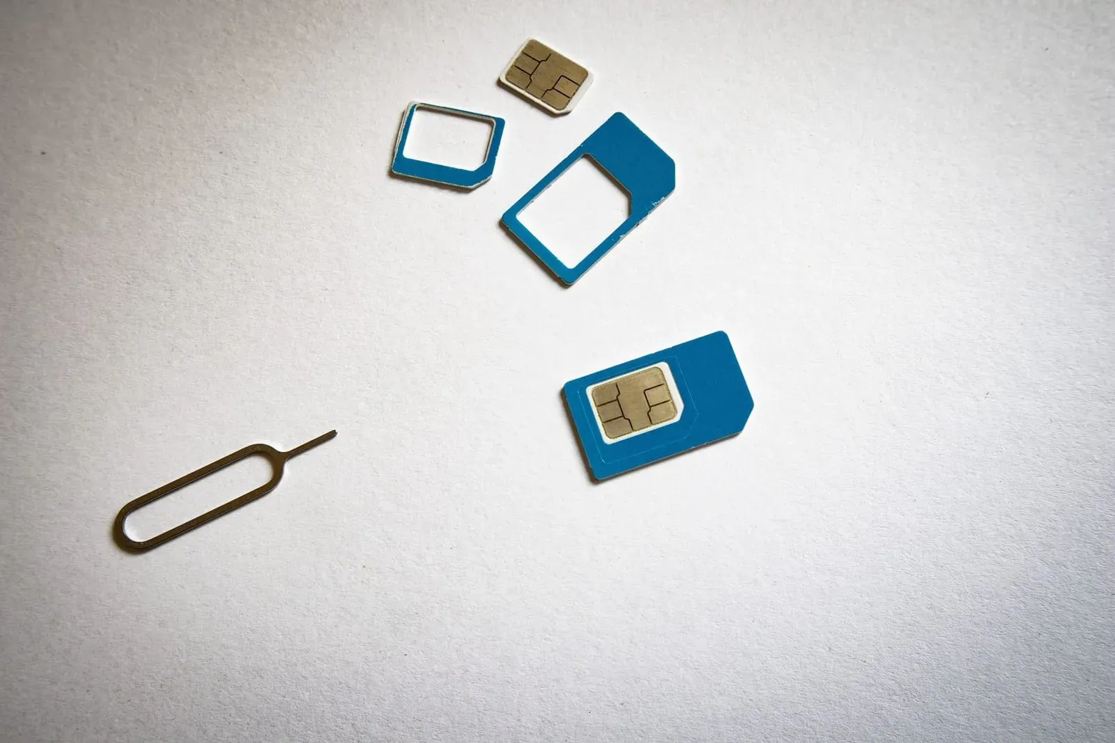 Close-up of SIM cards and an ejector tool laid flat, used for a Koh Samui tourist SIM setup