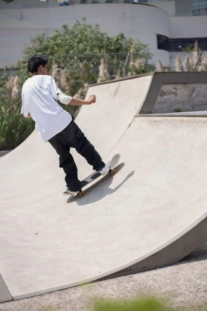 Teenage skateboarder riding a sunny urban skatepark, the age group behind most street skating on Koh Samui