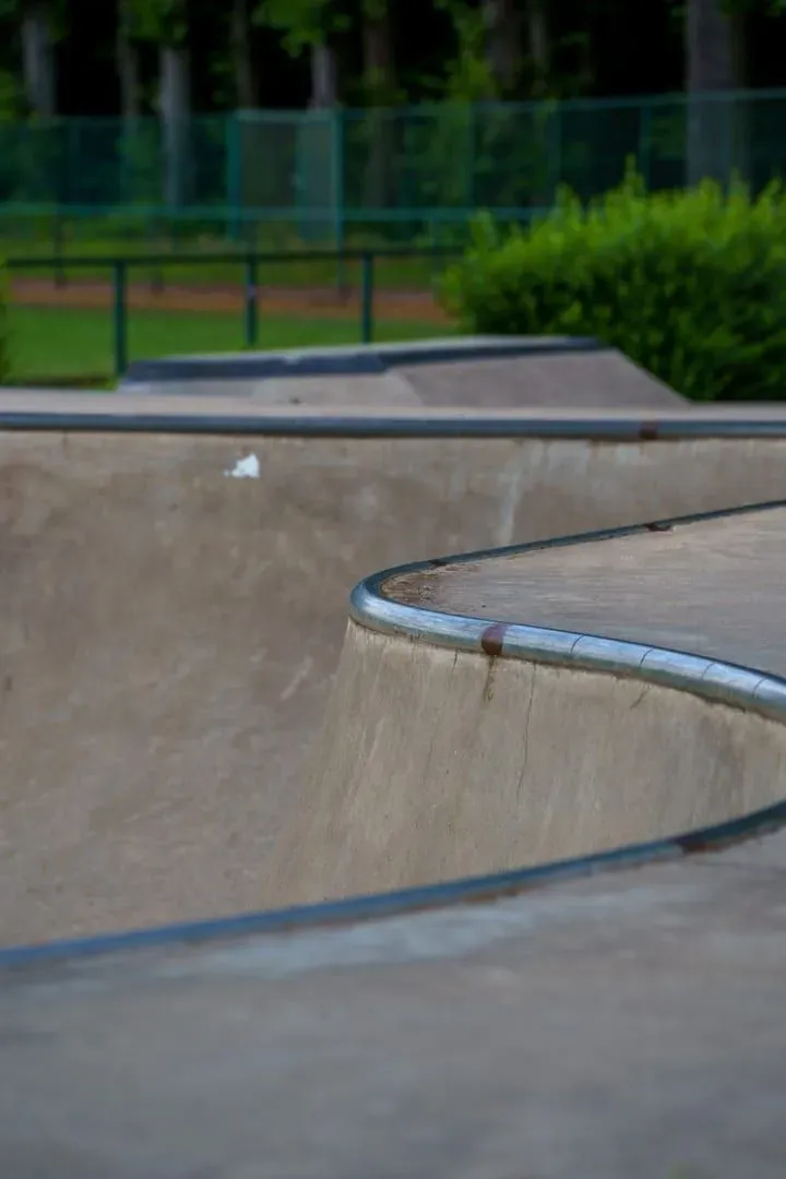 Curved concrete skate ramp in a green outdoor setting, the kind of facility Koh Samui does not yet have