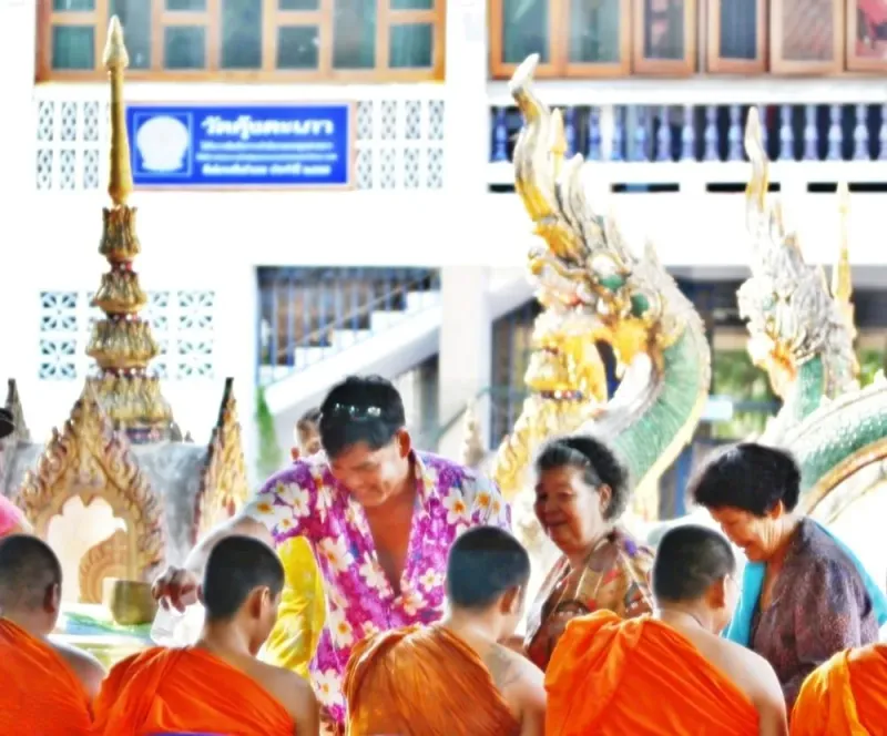 Locals gathered at a Thai temple for a Songkran water ceremony honouring Buddha images