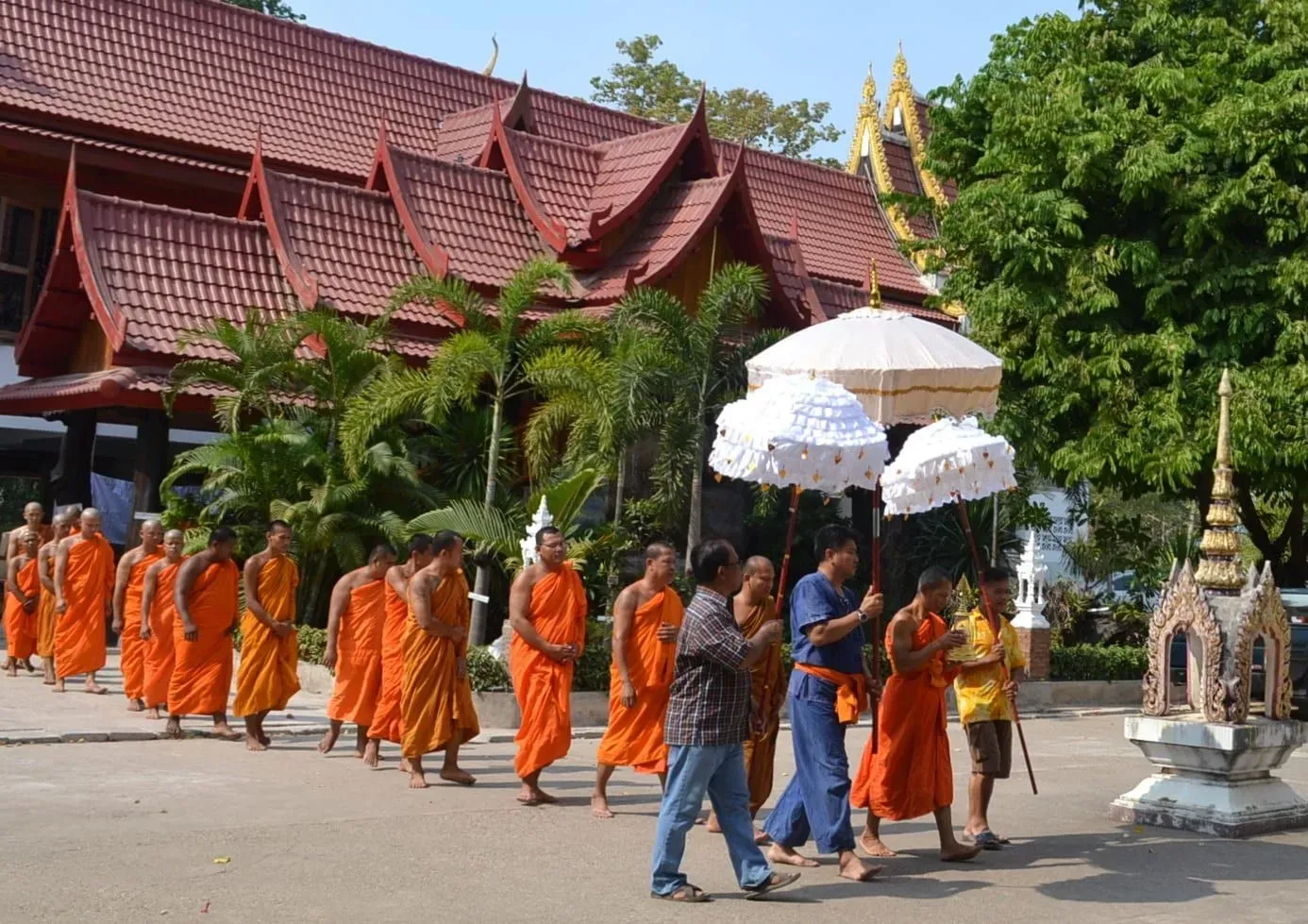 Visitors sprinkling water over a Buddha image at a Thai temple during the Songkran festival