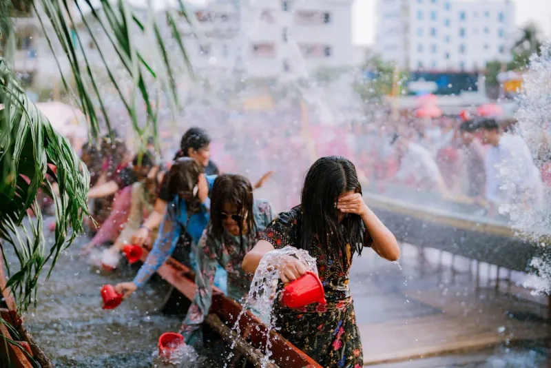 People gathered in the street for a joyful water festival celebration during the hot season