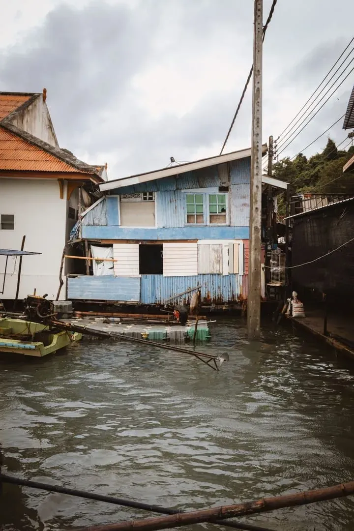 Traditional wooden stilt house on a canal in Surat Thani near the ferry route to Koh Samui
