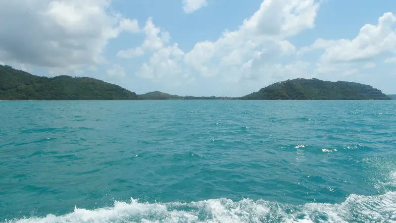Hazy hills along Koh Samui's southwest coast, seen from the water near Taling Ngam
