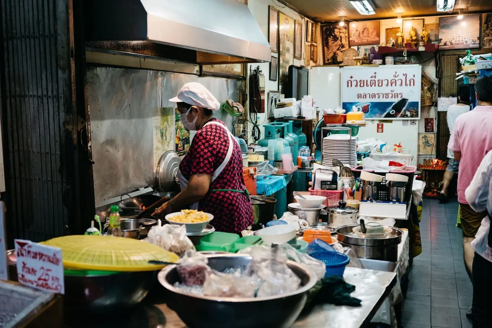 Chef selecting fresh produce at a Thai market stall before a Koh Samui cooking class