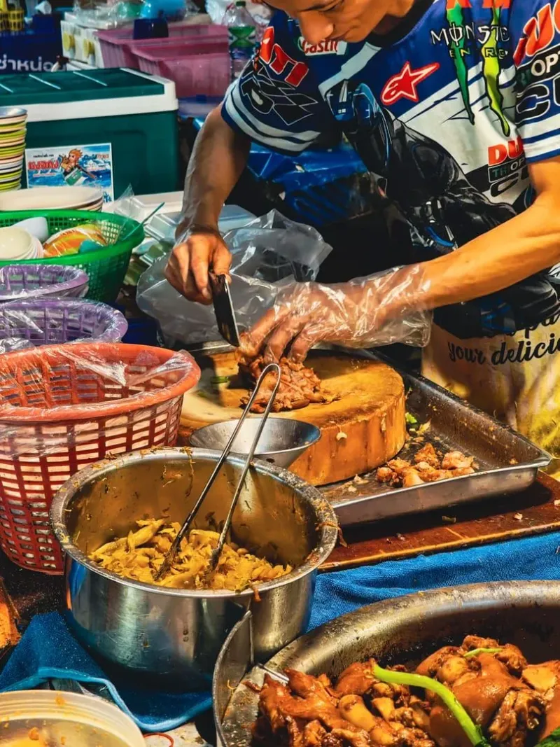 Street vendor preparing Thai cuisine, the same techniques taught in Koh Samui cooking classes