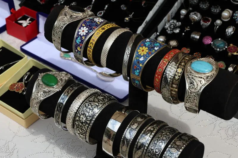 Silver bracelets displayed for sale at a jewellery market stall
