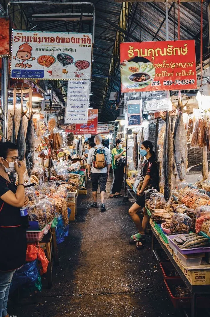 Shoppers browsing a busy fresh seafood market near Koh Samui