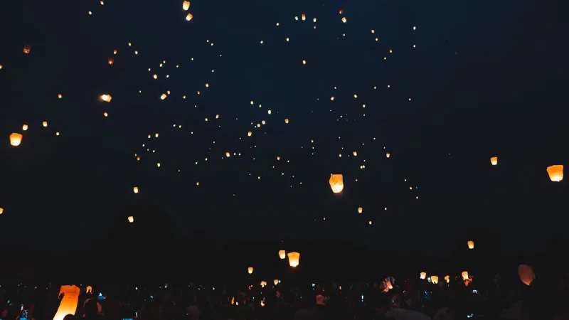 Numerous floating lanterns lighting up a cultural festival night similar to Koh Samui's temple celebrations