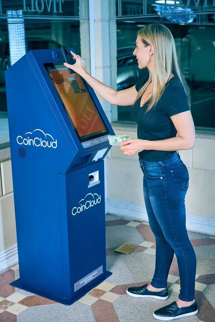 Woman using a cash machine to withdraw baht for a Koh Samui trip budget
