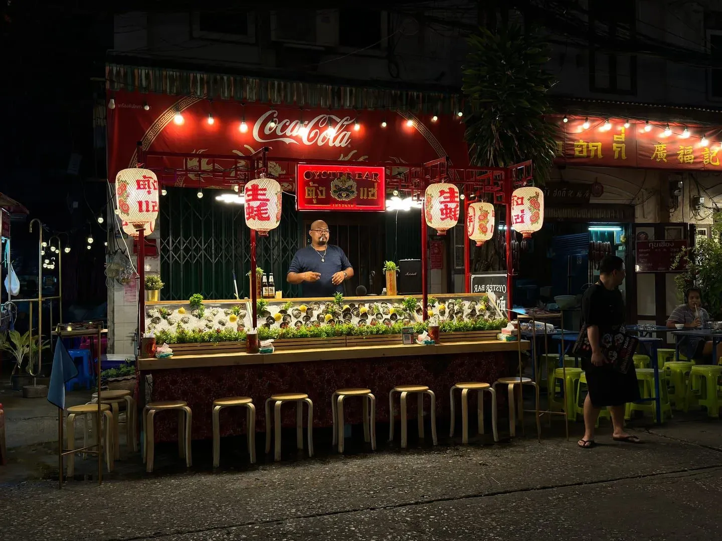Illuminated food stall with hanging lanterns at a Koh Samui night market street