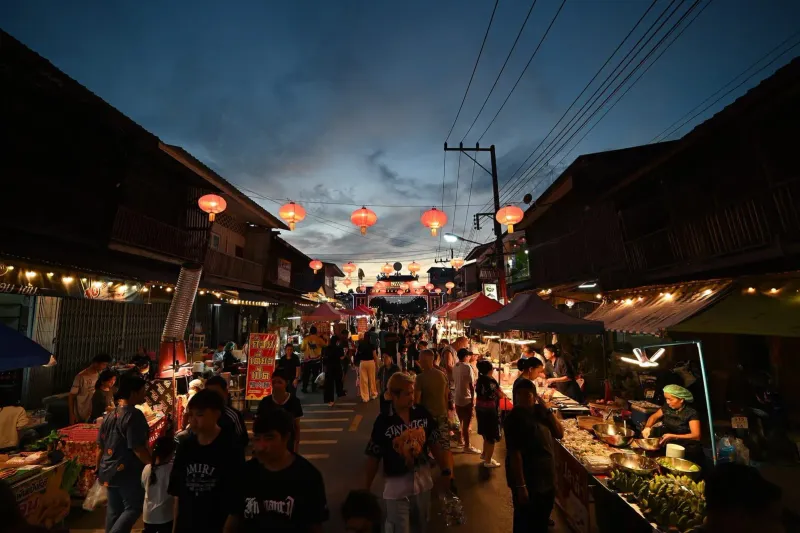 Lantern-lit archway leading into a bustling Koh Samui night market
