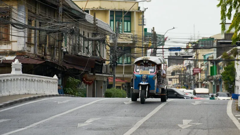 Metered taxi parked on a Bangkok street, similar to cabs found on Koh Samui