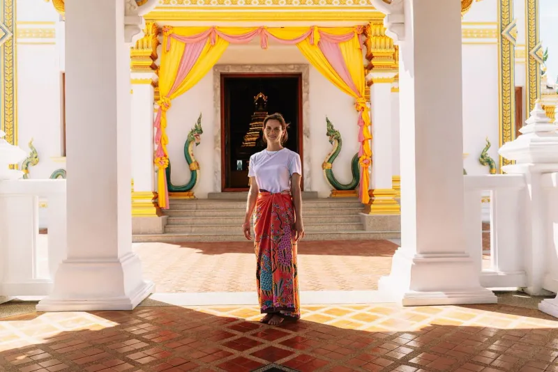 Vibrant temple entrance with traditional drapery showing appropriate temple attire Thailand