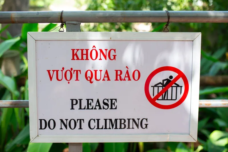 Bilingual outdoor warning sign typical of tourist safety notices in Thailand