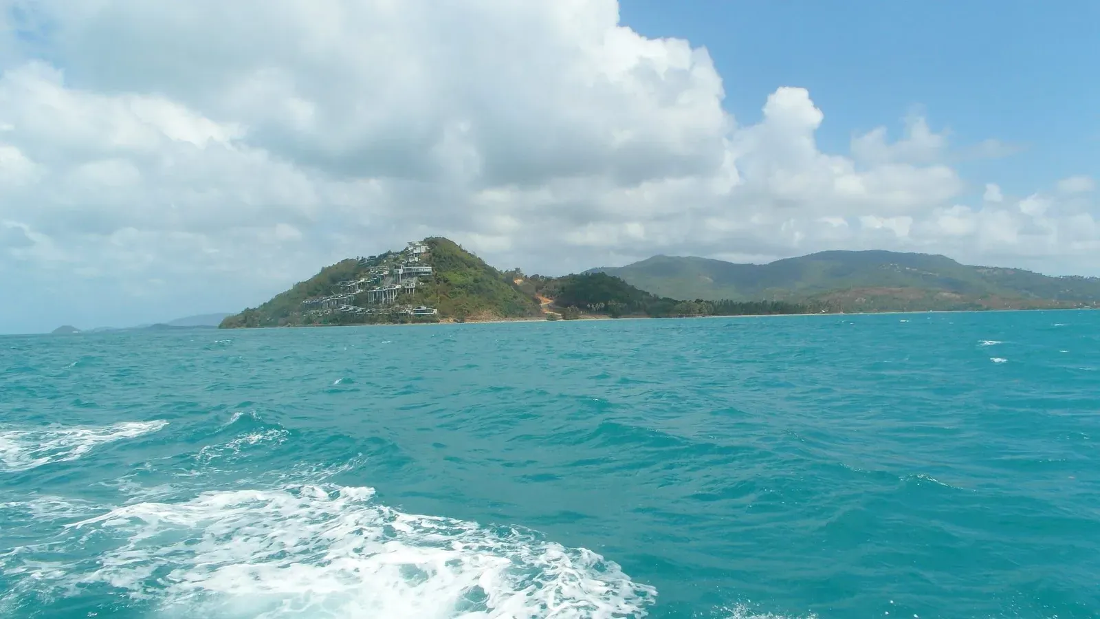 A terraced hillside resort on Koh Samui's southwest headland, seen from the water near Taling Ngam