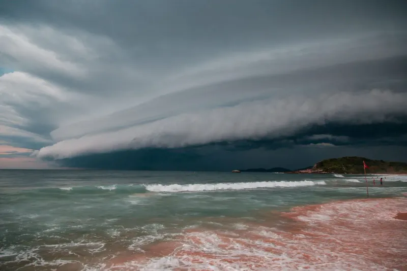 A dramatic thunderstorm cloudscape rolling toward a Koh Samui beach over rough ocean waves